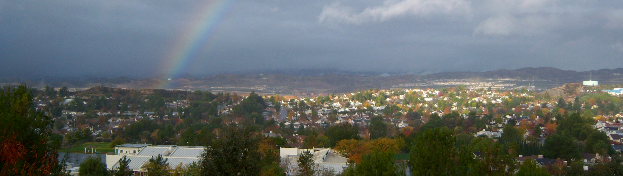 view of the town with a rainbow in the sky